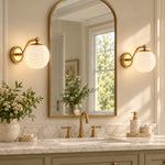Charger l'image dans la visionneuse de galerie, Two cream milk glass sconces on either side of a bathroom mirror
