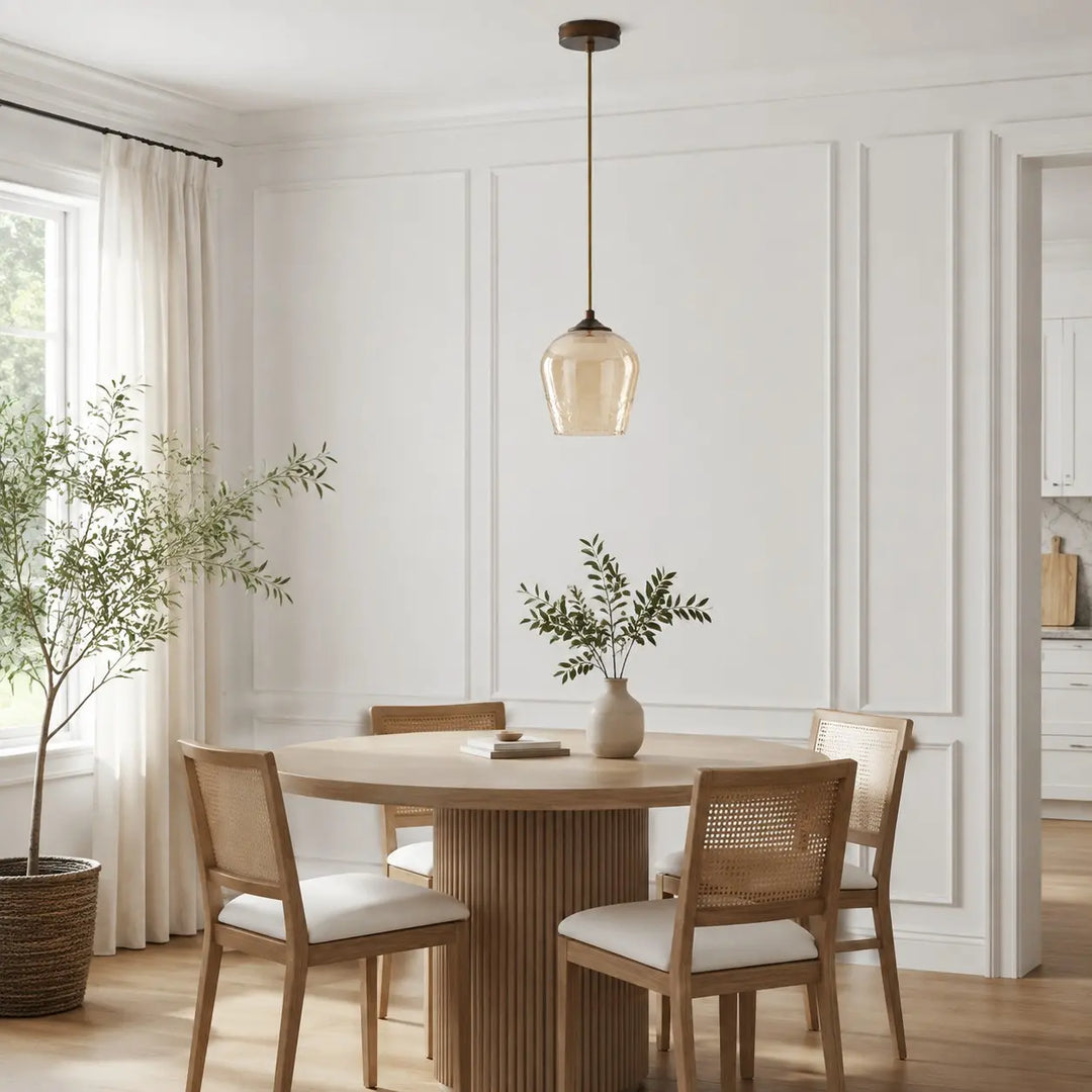 Amber glass pendant light above a dining table