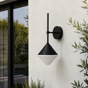 black and white outdoor wall sconce mounted on a garden exterior wall