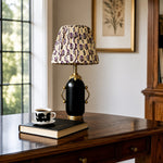 Load image into Gallery viewer, Matte black floral table lamp on a wooden console table