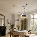 Charger l'image dans la visionneuse de galerie, Pair of adjustable chrome pendant lights in a bright dining room