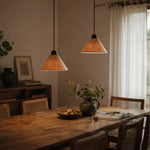 Load image into Gallery viewer, Warm lit natural paper pendant lamps in a dining room