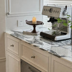 Cargar imagen en el visor de la Galería, Polished silver-tone cabinet knobs installed on light kitchen cabinets