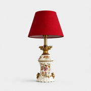 Red floral ceramic table lamp on a light background