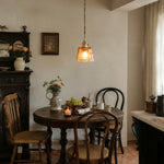 Load image into Gallery viewer, Amber glass pendant light in a vintage dining room