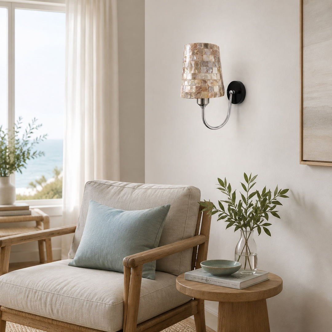 Capiz shell wall sconce beside a lounge chair and side table