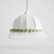 Soft green scalloped lace fabric pendant lamp on a light background