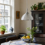 Load image into Gallery viewer, Clear ribbed glass pendant light above a table with plants