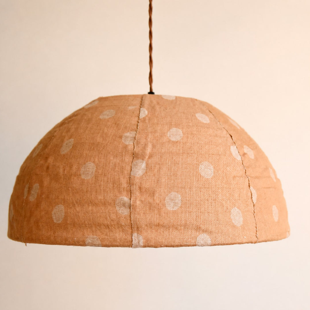 Close view of curved linen pendant shade