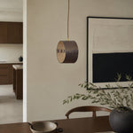 Bild in Gallery-Viewer laden, Hand-laced leather cylinder pendant light in an interior setting