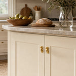 Load image into Gallery viewer, Pair of abstract brass face cabinet knobs on light kitchen cabinetry