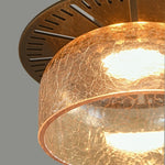 Cargar imagen en el visor de la Galería, Amber glass pendant shade glowing beneath a brass top