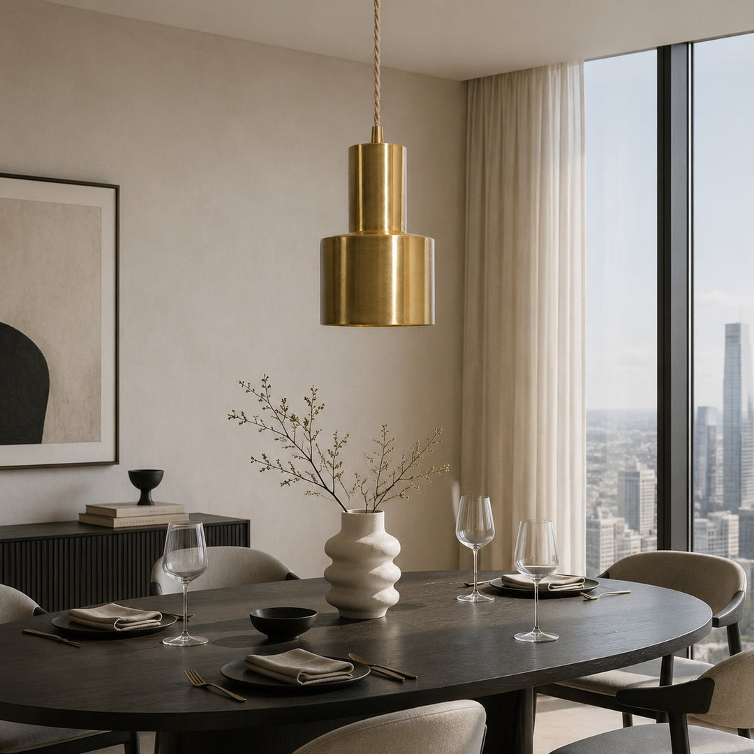 Vintage brass pendant lamp above a modern dining table
