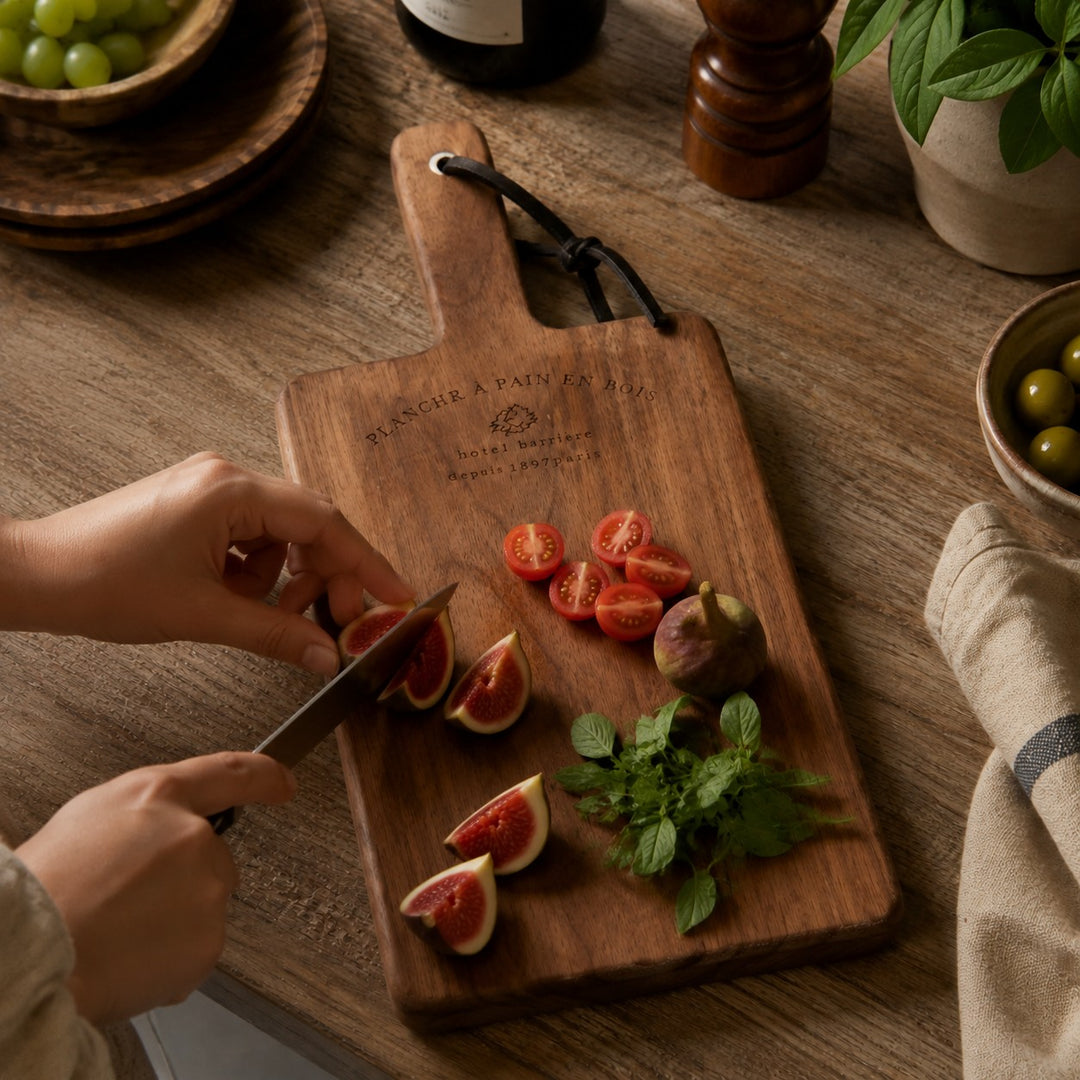 Handled wood cutting board used for fruit preparation
