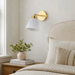 Load image into Gallery viewer, Ceramic and brass wall sconce beside a bright bedroom window