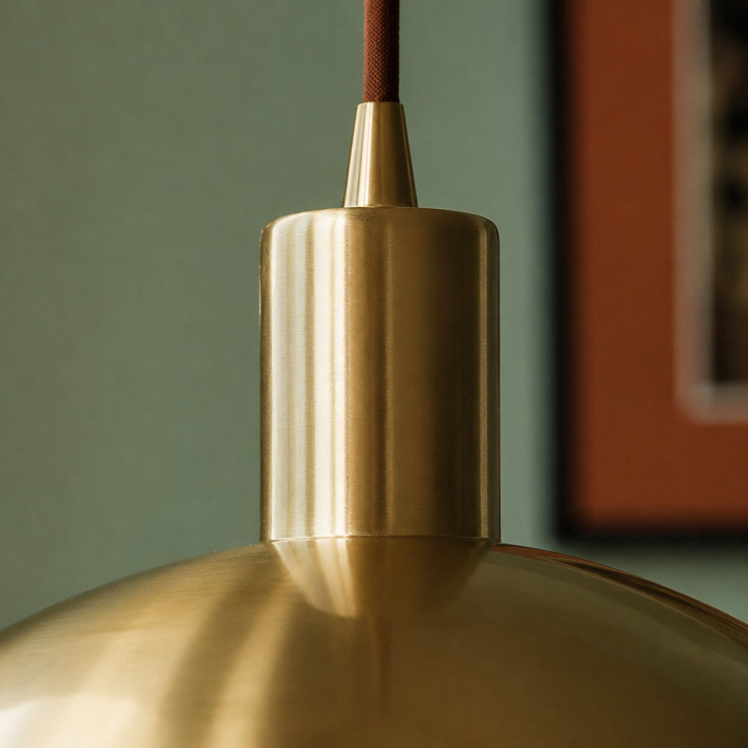 Close view of brass pendant stem and ceiling connection