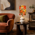 Load image into Gallery viewer, Liberty floral ceramic table lamp beside a lounge chair