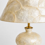 Cargar imagen en el visor de la Galería, Close view of capiz shell shade, brass-tone stem, and rounded base