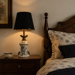 Load image into Gallery viewer, Blue porcelain motif table lamp beside a wooden bed