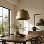 Load image into Gallery viewer, Antique brass pendant lamp above a dining table
