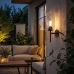 Load image into Gallery viewer, Outdoor wall sconce lit beside seating area