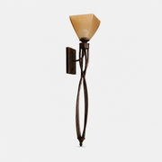 Sculptural aged bronze amber glass wall sconce on a light background