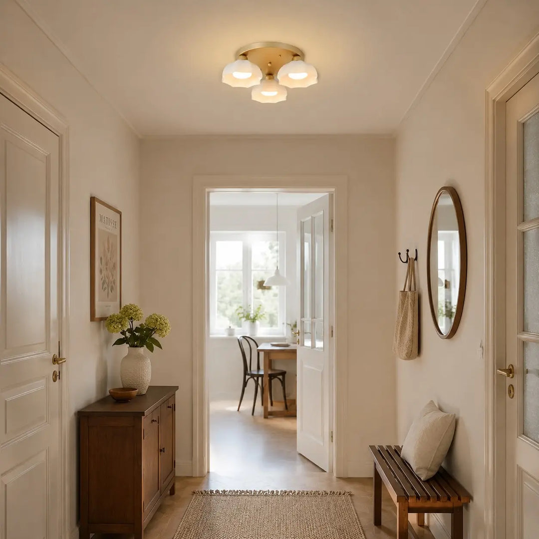Gold and white glass ceiling light in a hallway