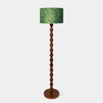Load image into Gallery viewer, Full view of sculptural wood floor lamp with patterned fabric drum shade