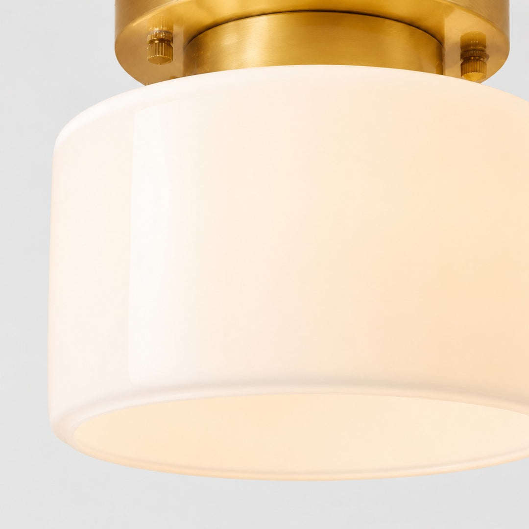 Close detail of frosted glass shade and brass ceiling plate