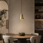 Load image into Gallery viewer, Bell-shaped natural brass pendant light in a warm dining room