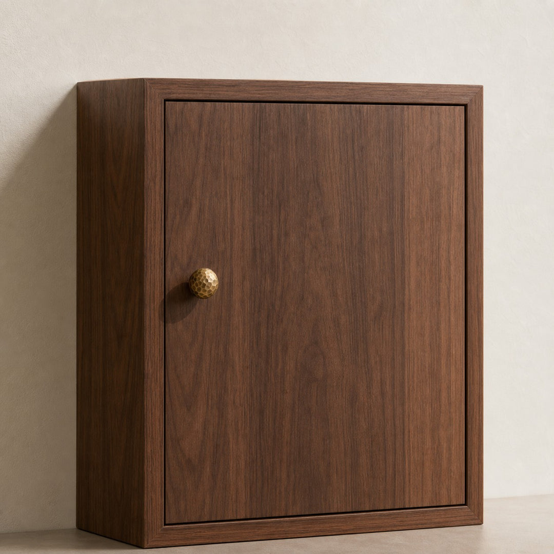 Small antique brass knob on a cabinet door