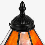 Load image into Gallery viewer, Close view of black metal finial and ribbed frame on the stained glass shade