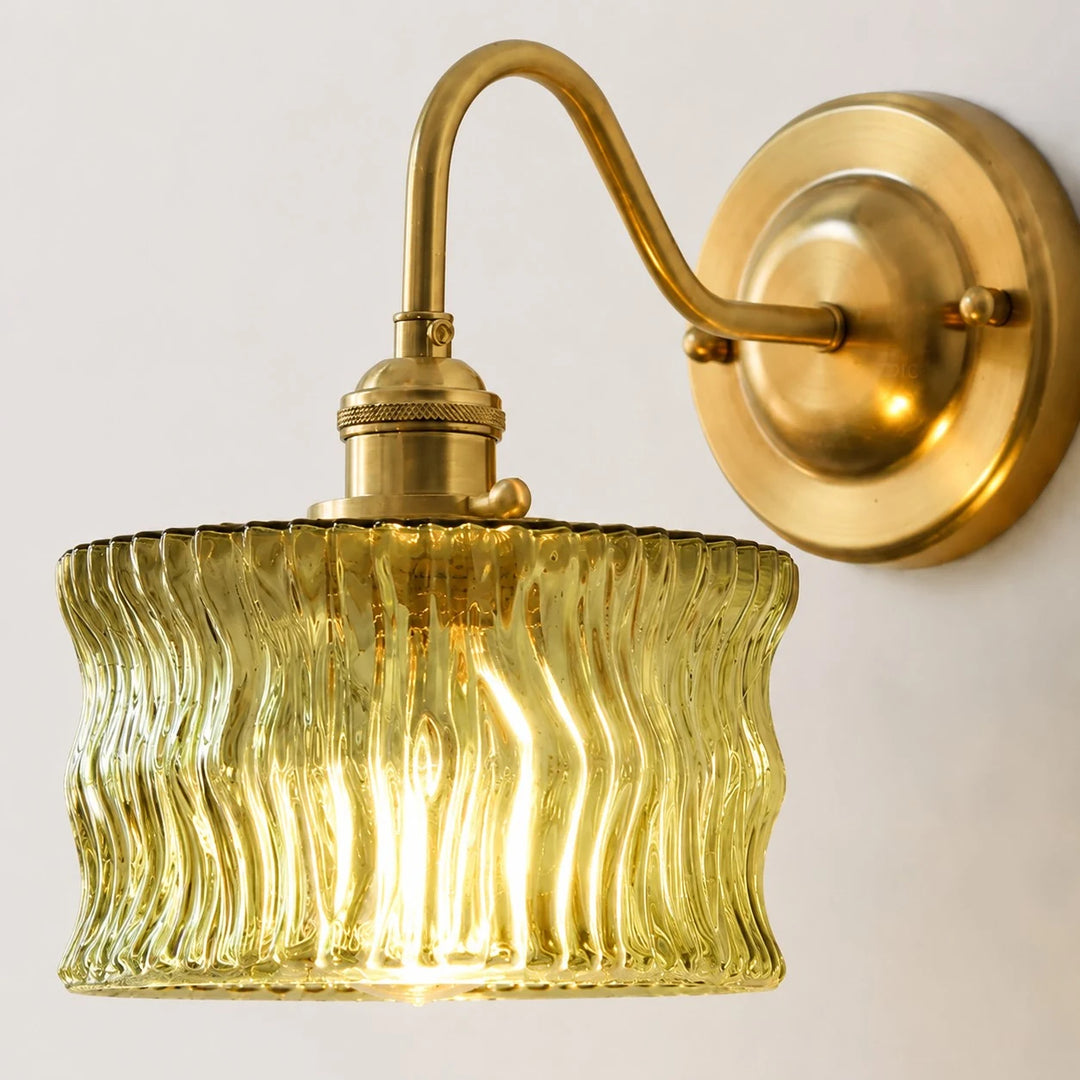 Close detail of olive ripple glass and brushed brass wall plate
