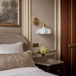 Bild in Gallery-Viewer laden, Blue milk glass brass wall sconce beside a bed
