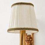 Bild in Gallery-Viewer laden, Close view of the white pleated fabric lampshade with brass trim