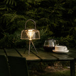 Load image into Gallery viewer, Solar garden lantern glowing on an outdoor table at night