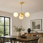 Load image into Gallery viewer, Milk glass chandelier above a modern dining table