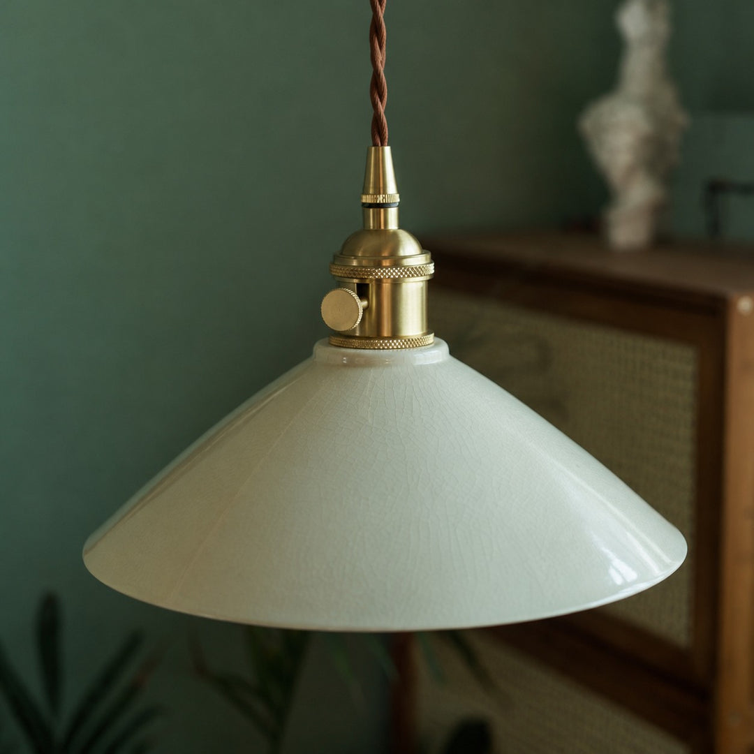 Brass-tone socket and ceramic shade detail