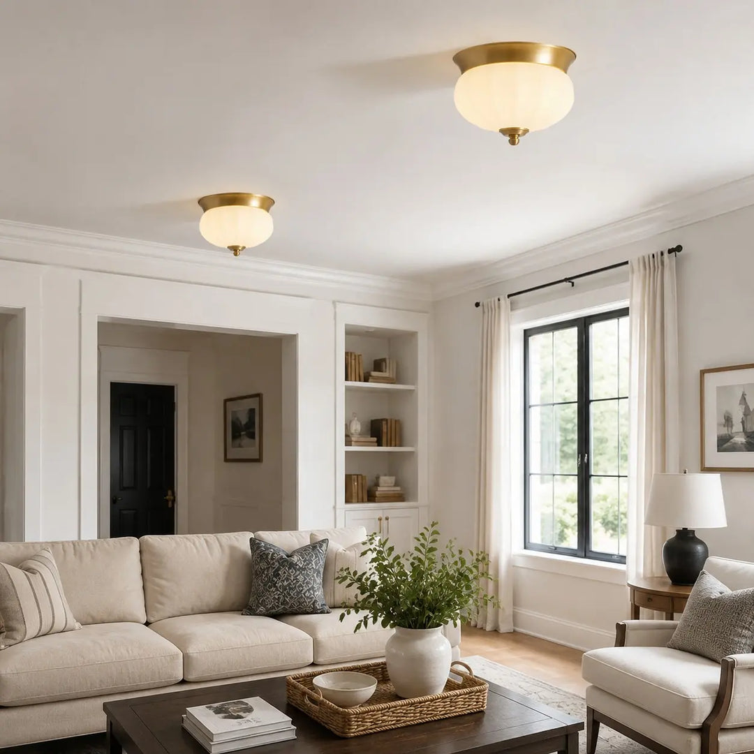 Pair of compact brass ceiling lights in a living room
