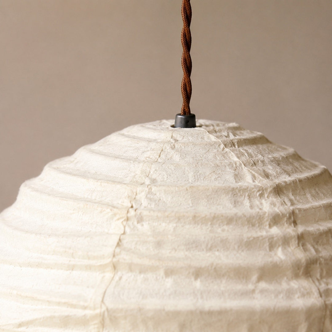 Close view of pendant cord and upper linen shade connection