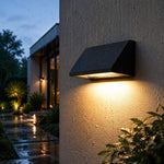 Bild in Gallery-Viewer laden, Black sloped outdoor wall light illuminated on a clean background