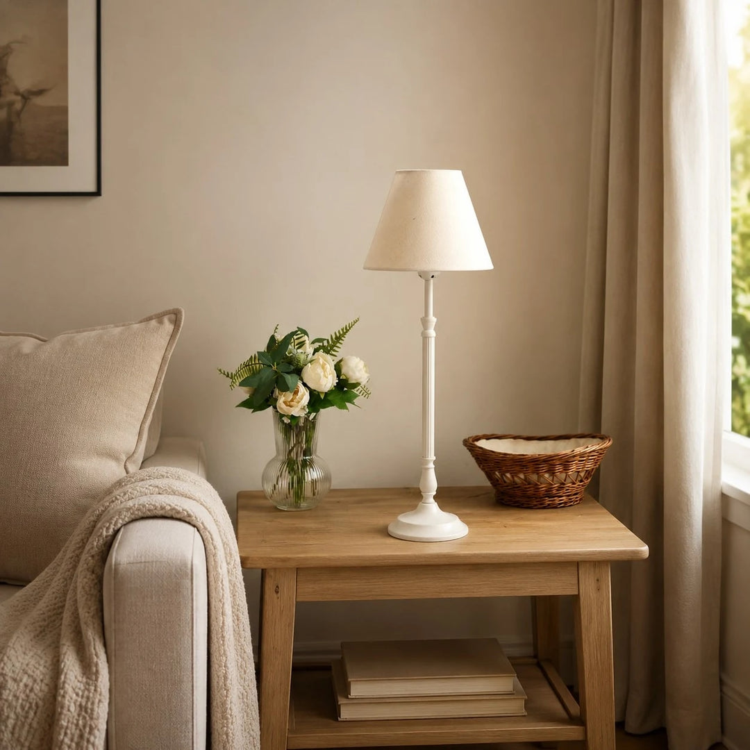 Ivory French country table lamp on a bedside table