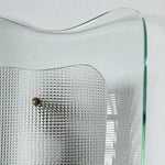 Bild in Gallery-Viewer laden, Close view of clear glass wall sconce and textured inner shade