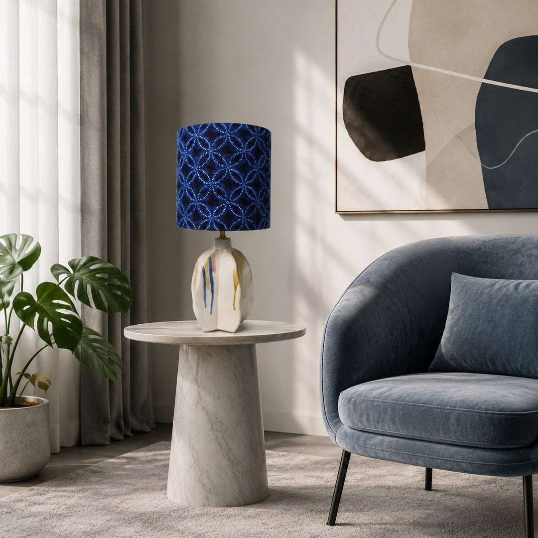 Blue patterned ceramic table lamp beside a lounge chair