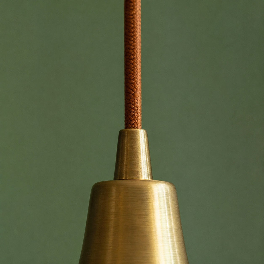 Close view of the pendant cord and brass canopy connector