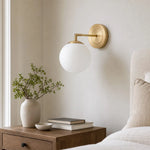 Load image into Gallery viewer, Milk glass wall lamp beside a neutral upholstered bed