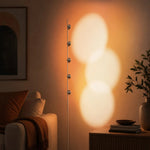 Cargar imagen en el visor de la Galería, Sunset projection floor lamp glowing beside a lounge chair