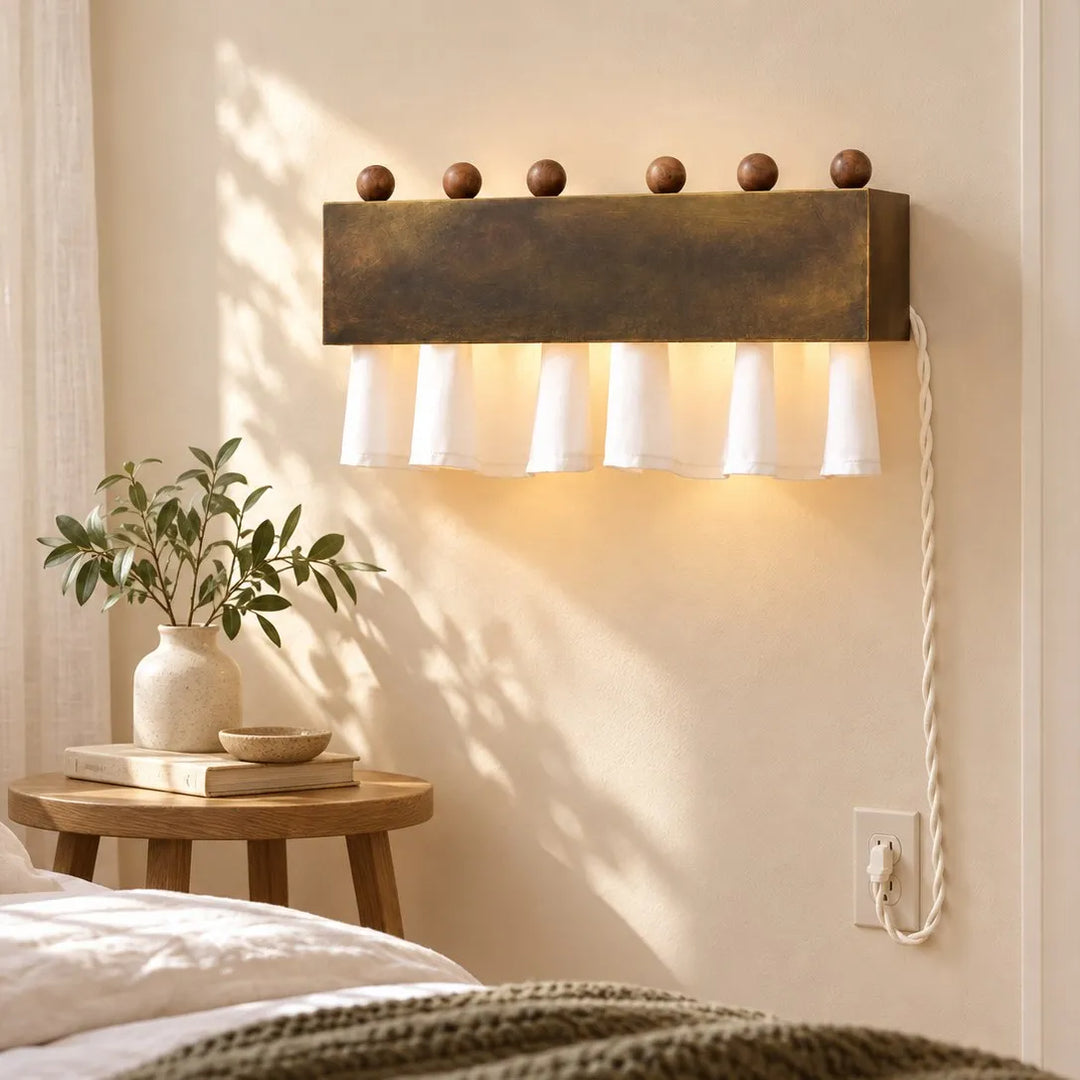 Dark antique bronze plug-cord curtain wall lamp in a bright bedroom