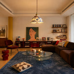 Load image into Gallery viewer, Blue and white ceramic pendant lamp glowing in a warm living room