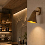 Cargar imagen en el visor de la Galería, Brass cone wall lamp in a warm lounge setting
